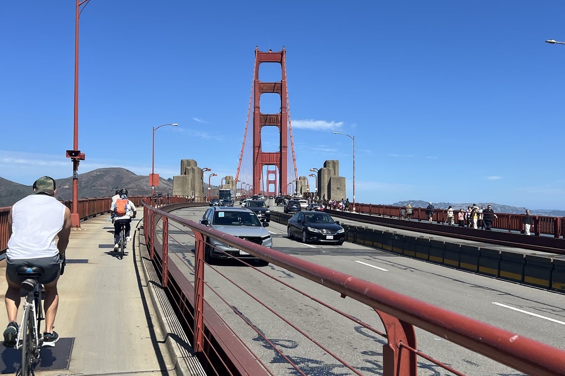 Riding across the Golden Gate Bridge bike path toward the north tower