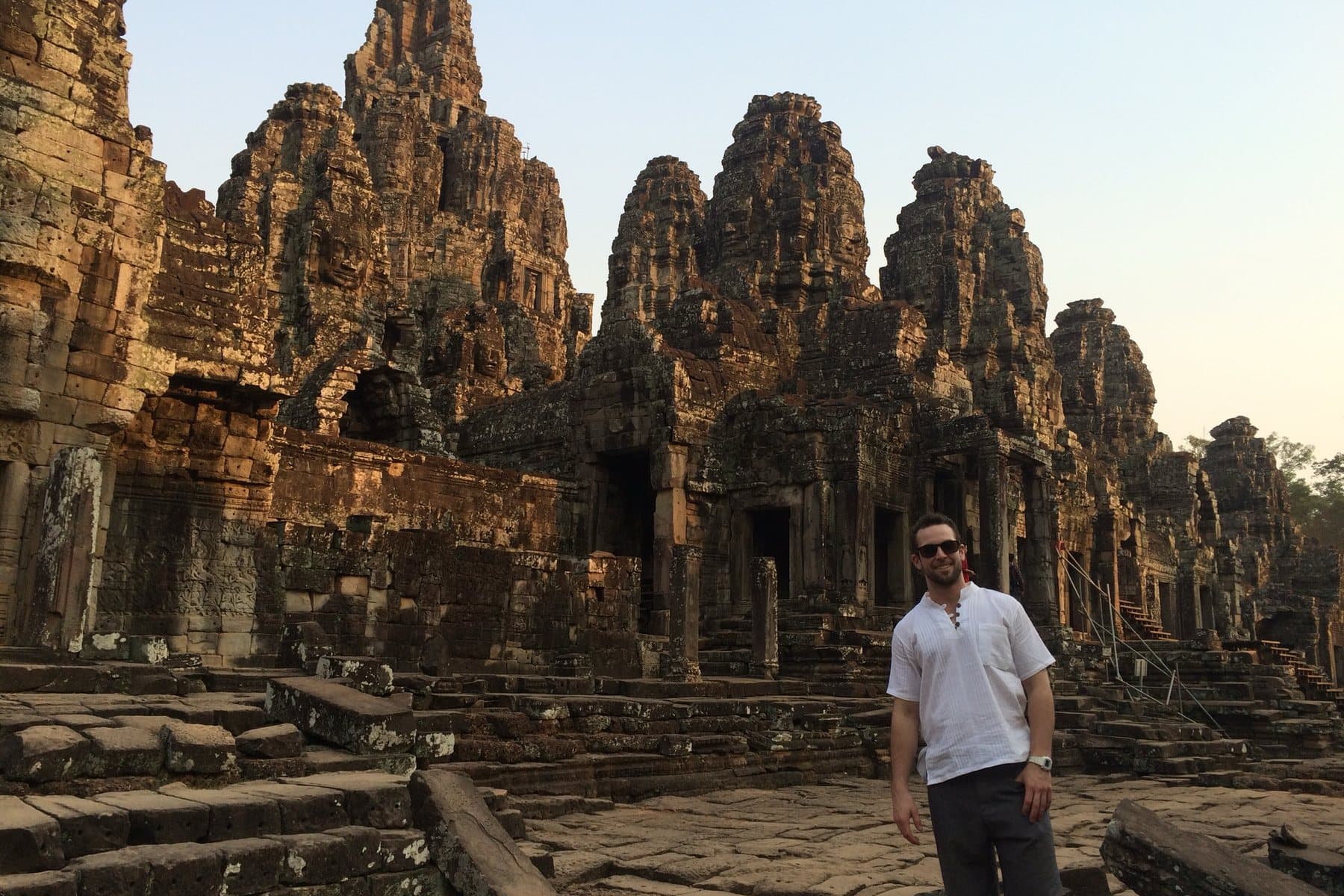 Daniel at the Bayon temple at Angkor, Cambodia, in late-afternoon light